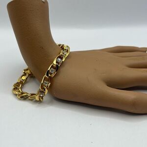 JBK gold tone chain bracelet , with CZ stones.